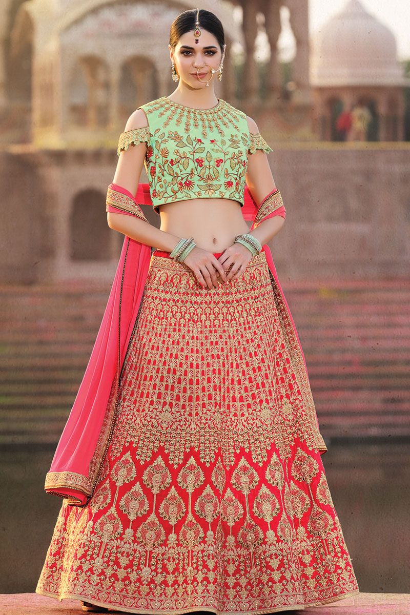 CREAM IVORY BANARASI LEHENGA SET AND A MIRROR EMBROIDERED CONTRAST RED  BLOUSE PAIRED WITH A MULTI COLOURED EMBROIDERED PATCHWORK DUPATTA AND LIGHT  GOLD EMBELLISHMENTS. - Seasons India